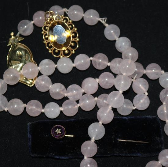 A rose quartz bead necklace with 18ct gold clasp. a gold and citrine pendant and a 9ct gold stick pin.